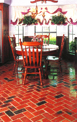 Concrete brick floor in herringbone pattern.