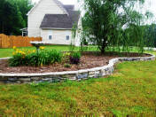 Raised flower bed using Ledgestone veneer over concrete wall by Rob Norman.